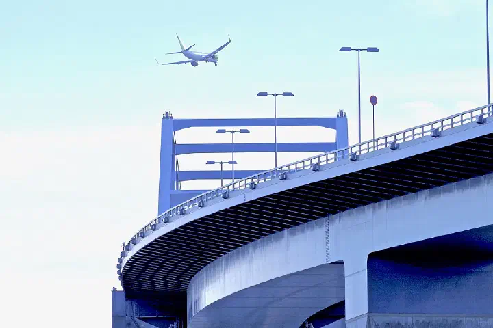 Jetliner approaching Haneda Airport over the Tokyo Gate Bridge in Tokyo Bay