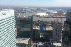 The O2 arena between the HSBC, Canary Wharf, Barclays and Citi buildings, London.