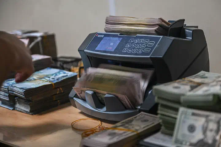 A cash counter machine flips through U.S. currency bills during a cash count conducted by the 386th Air Expeditionary Wing financial management