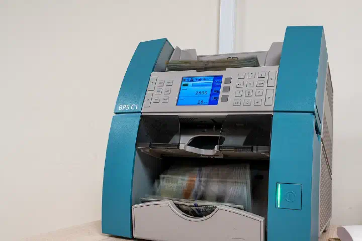 A money counting machine is used at an undisclosed location within the U.S. Central Command area of responsibility, Jan. 12, 2024
