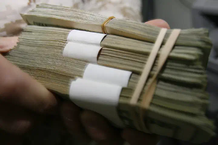 Chief Warrant Officer 2 Charles E. Dennis, 32, from Massillon, Ohio, begins his count of the Camp Taqaddum Disbursing office's money reserve June 29