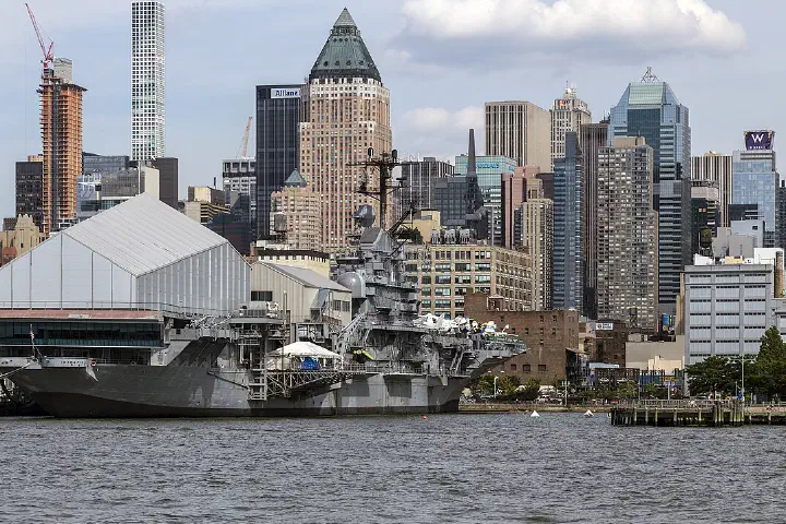 The Intrepid Sea Air Space Museum and the West Side skyline of Manhattan from the Hudson River, New York