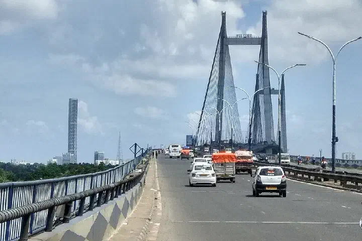 Kolkata skyline from Vidyasagar Setu, the 42, The Maidan and Fort william area is visible, sunny day, cloudy sky