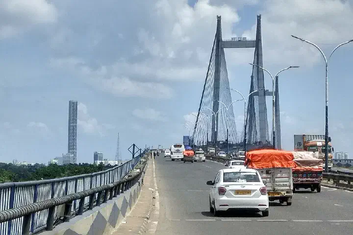Kolkata skyline from Vidyasagar Setu, the 42, The Maidan and Fort william area is visible, sunny day, cloudy sky
