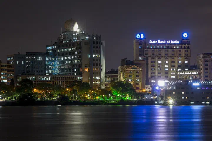 A view of the New Secretariat (left) and State Bank of India (right) buildings at night from across the Hooghly river