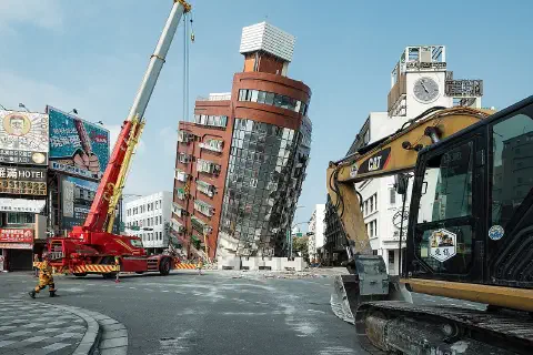 Rescue workers near the semi-collapsed ten-story Uranus Building on Xuanyuan Road after the 2024 Hualien earthquake