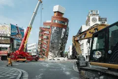 Rescue workers near the semi-collapsed ten-story Uranus Building on Xuanyuan Road after the 2024 Hualien earthquake.