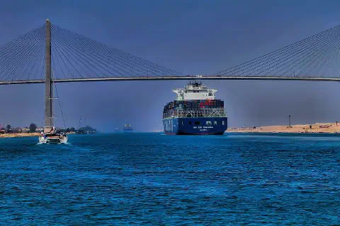 The container ship CMA CGM Thalassa passing the Suez Canal Bridge.