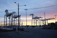 Cargo cranes at dusk at the Howard Terminal, Oakland Inner Harbor.