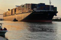 At sunset, the CMA CGM Marco Polo traveling through the Savannah Port, Georgia
