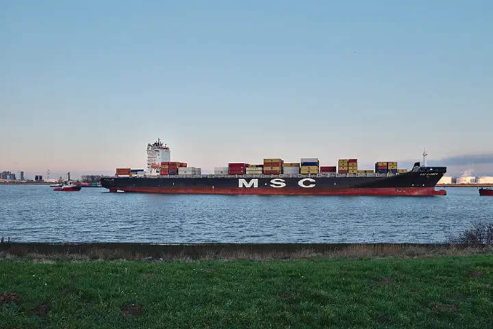 MSC Carmen container ship being towed in the Scheldt towards the Port of Antwerp, seen from Doel, Belgium