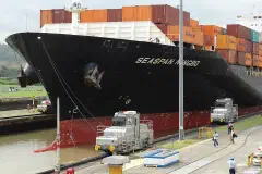 Locomotives tow a container ship through the Miraflores Locks on the Panama Canal.